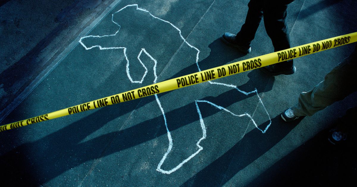 This stock photo shows a chalk outline at a police crime scene.