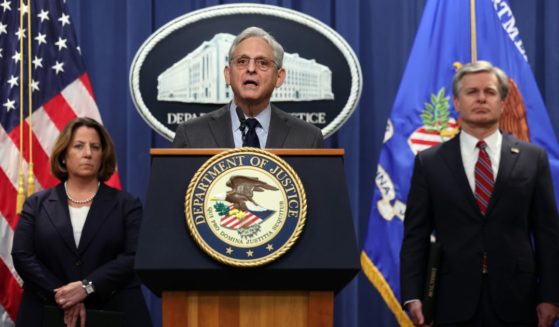 Attorney General Merrick Garland, center, Deputy Attorney General Lisa Monaco, left, and FBI Director Christopher Wray hold a news conference at the U.S. Department of Justice in Washington on Monday to announce charges against 13 individuals, including members of Chinese intelligence and their agents, for alleged efforts to unlawfully exert influence in the United States for the benefit of the government of China.