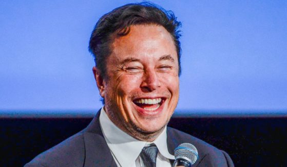 Tesla CEO Elon Musk laughs while talking to guests at the Offshore Northern Seas 2022 meeting in Stavanger, Norway, on Aug. 29.
