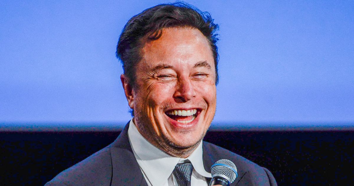 Tesla CEO Elon Musk laughs while talking to guests at the Offshore Northern Seas 2022 meeting in Stavanger, Norway, on Aug. 29.