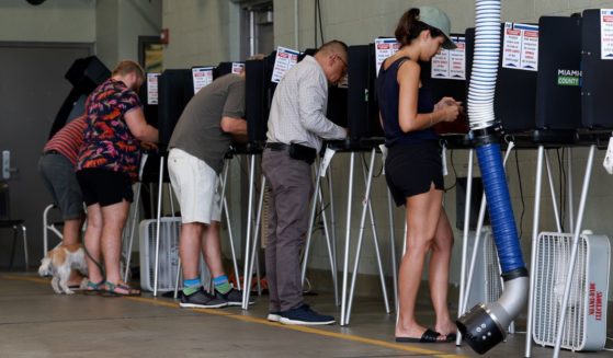 Voters cast their primary ballots at a polling station set up in a fire station in Miami Beach, Florida, on Aug. 23.