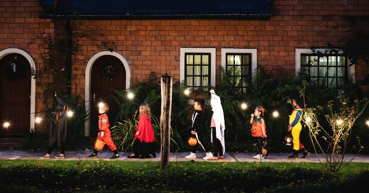 Children in Halloween costumes go trick-or-treating.