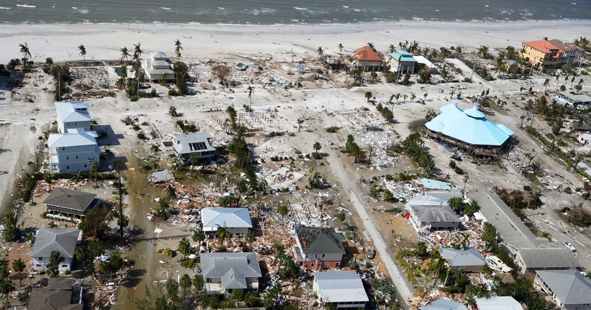 Damaged homes and debris in Fort Myers Beach are shown in the wake of Hurricane Ian Thursday. Florida officials are warning residents to be on the alert for the next wave of danger, this time from predatory insurance scam artists.