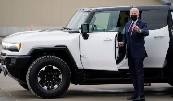 Joe Biden getting into a white electric Hummer