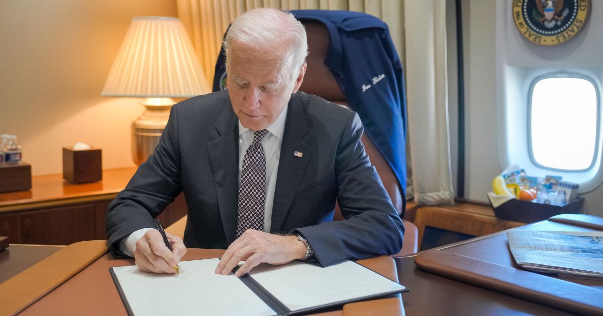 Joe Biden signing something