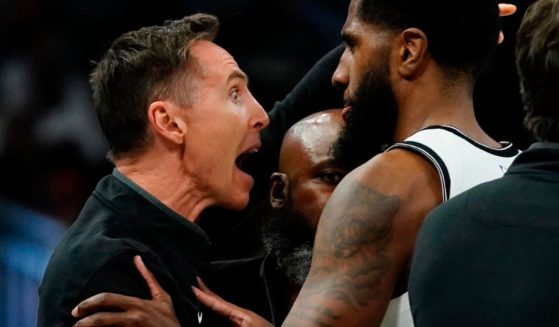 Brooklyn Nets head coach Steve Nash is restrained after having a technical foul called on him during the second half of a game at Fiserv Forum in Milwaukee on Wednesday.