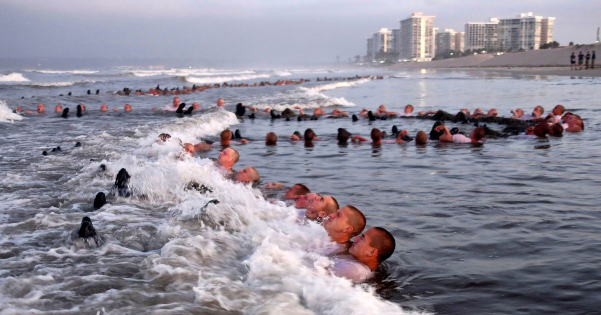 Navy SEAL candidates participate in "surf immersion" during Basic Underwater Demolition/SEAL (BUD/S) training at the Naval Special Warfare Center in Coronado, Calif.,in a file photo from May 2020. A new report says the Naval Special Warfare Command has reprimanded three officers in connection with the February 2022 death of SEAL candidate Kyle Mullen, who collapsed and died of acute pneumonia just hours after completing the grueling Hell Week test.