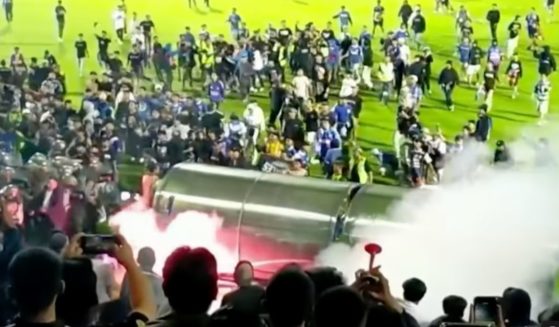 After fans stormed the field following a soccer game in Indonesia on Saturday evening, police used tear gas in an attempt to disperse the crowd.