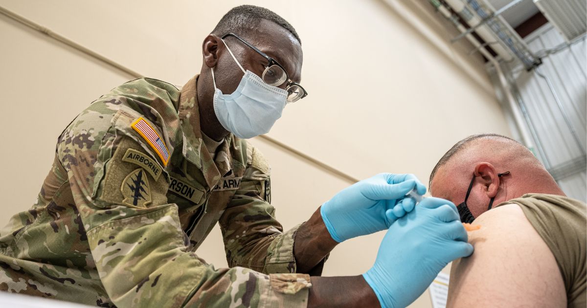 Sgt. 1st Class Demetrius Roberson administers a COVID-19 vaccine to a soldier at Fort Knox, Kentucky, on Sept. 9, 2021.