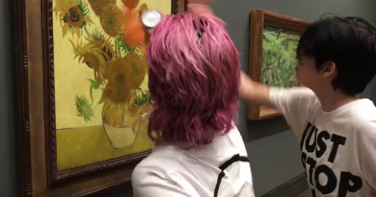 The two protesters opened cans of tomato soup and threw them at the famous painting before gluing their hands to the wall.
