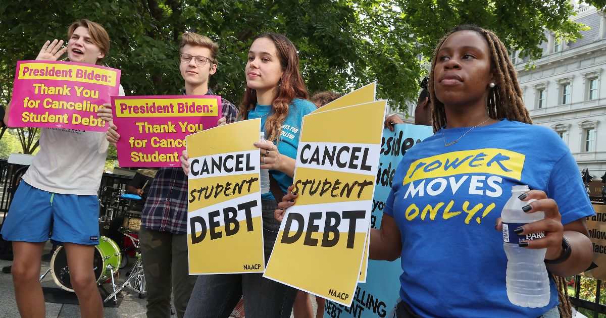 Student loan borrowers stage a rally in front of the White House in a file photo from Aug. 25. The students were celebrating President Biden's agreement to cancel as much as $10,000 to $20,000 of student debt, but a new court decision has put the brakes on that process, pending further court review.