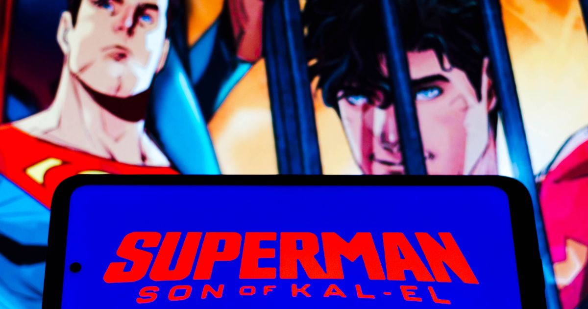 The logo for "Superman: Son of Kal-El" is displayed on a cellphone in this stock image.