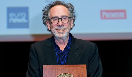 Tim Burton poses with his award during the Lumiere Award ceremony at the 14th Film Festival Lumiere in Lyon, France, on Friday.