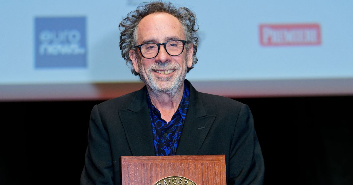 Tim Burton poses with his award during the Lumiere Award ceremony at the 14th Film Festival Lumiere in Lyon, France, on Friday.