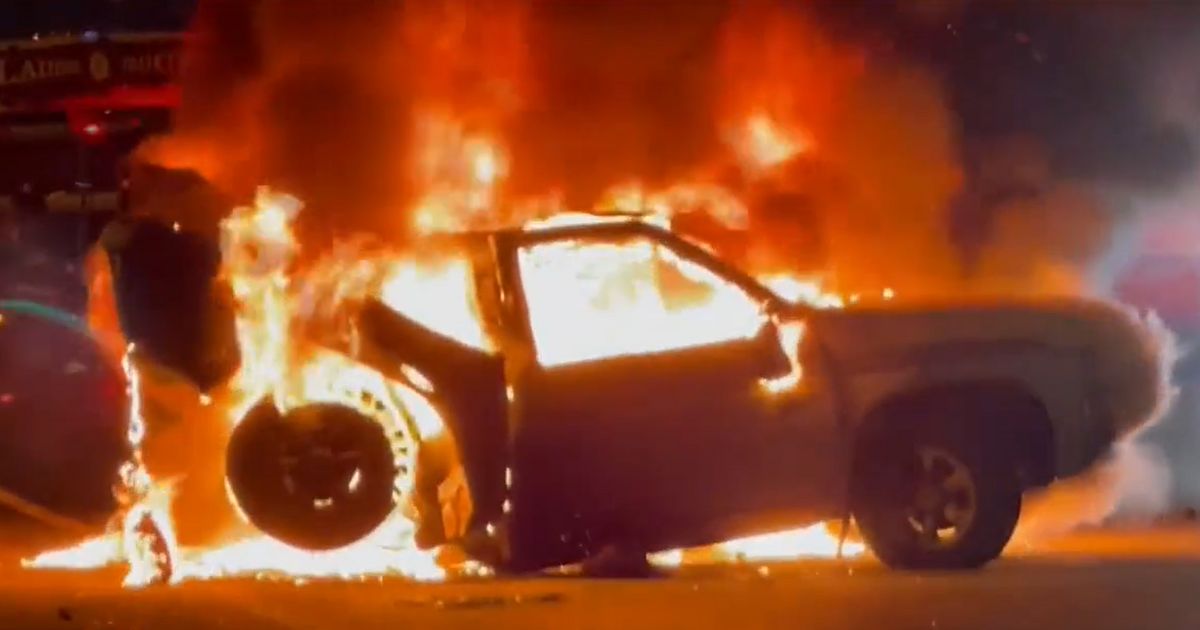 A pickup truck is in flames along Interstate 30 in Dallas on Sept. 27.