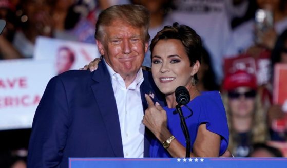 Arizona Republican gubernatorial candidate Kari Lake poses with former President Donald Trump during a rally in Mesa on Oct. 9.
