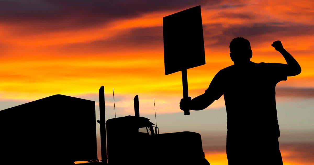 A striking truck driver is show in this stock image.