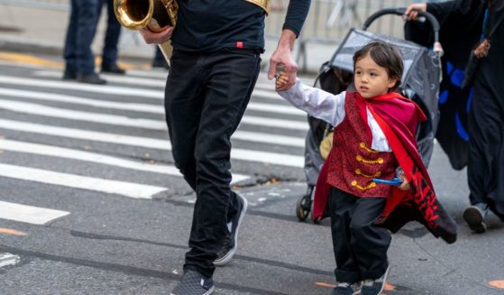 A child is dressed up for New York City's 48th annual Greenwich Village Halloween Parade on Oct. 31, 2021. In some schools in the country, Halloween is being canceled because it is viewed as an "exclusionary" holiday.