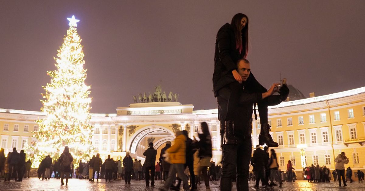 A couple takes a selfie photo at the Palace Square during the New Year celebration in downtown St. Petersburg, Russia, on Friday, Jan. 1, 2021. The