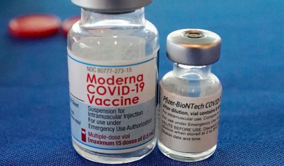 Vials of the Moderna and Pfizer COVID-19 vaccinations are shown in a September 2021 photo.