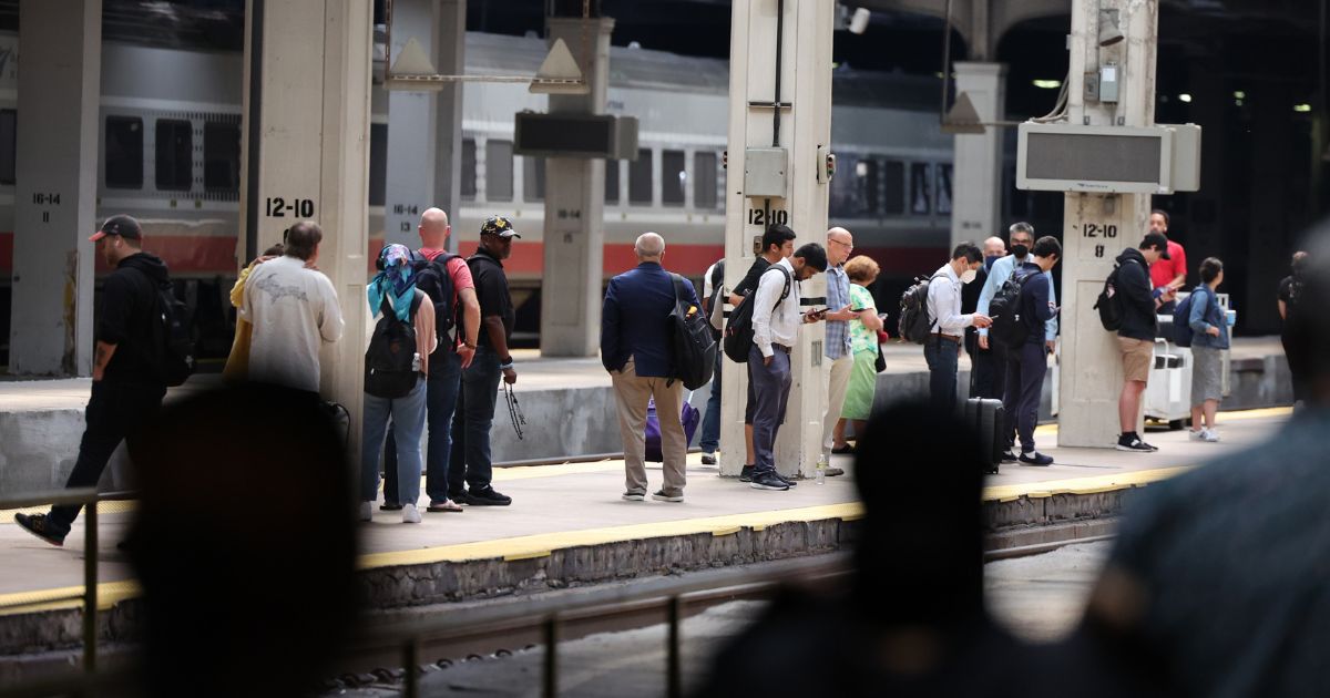 Passengers wait to board a Metra commuter train at Union Station in Chicago in September.