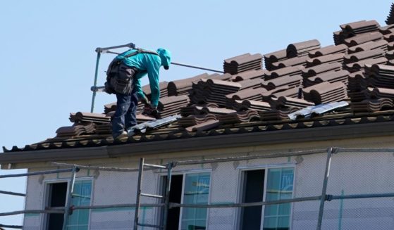 A worker on the roof of a home under construction in Folsom, California.