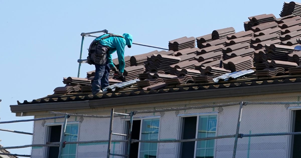 A worker on the roof of a home under construction in Folsom, California.