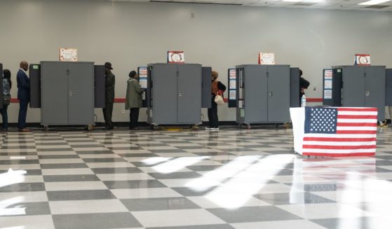 Democrat Sen. Raphael Warnock is pictured with other Georgian voters casting their early voting ballots on Monday in Atlanta.