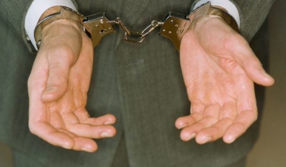 This stock image presents a businessman in cuffs.