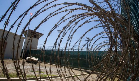 The control tower of Camp VI detention facility in Guantanamo Bay Naval Base, Cuba, is pictured through razor wire on April 17, 2019.