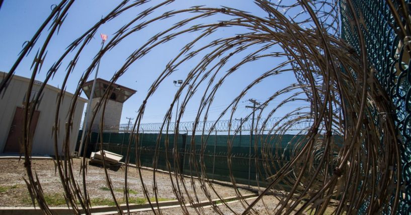 The control tower of Camp VI detention facility in Guantanamo Bay Naval Base, Cuba, is pictured through razor wire on April 17, 2019.