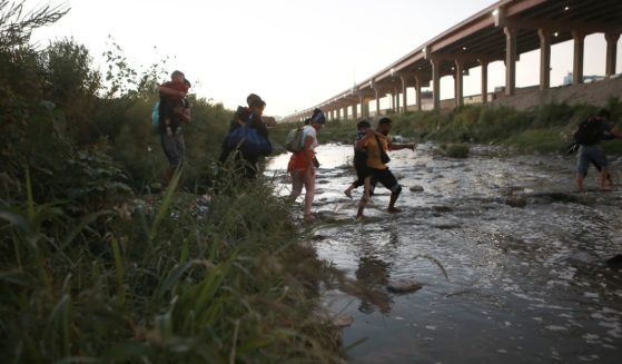 Venezuelan migrants walk across the Rio Brave towards the U.S. border from Cuidad Juarez, Mexico, on Oct. 13.