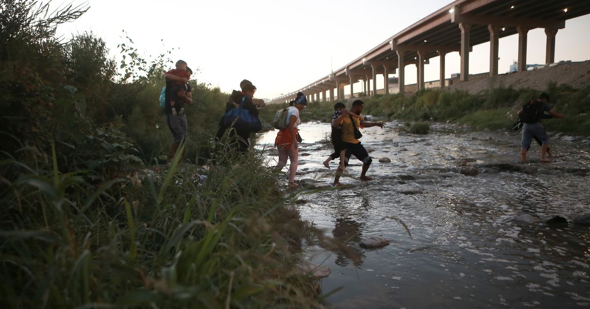 Venezuelan migrants walk across the Rio Brave towards the U.S. border from Cuidad Juarez, Mexico, on Oct. 13.
