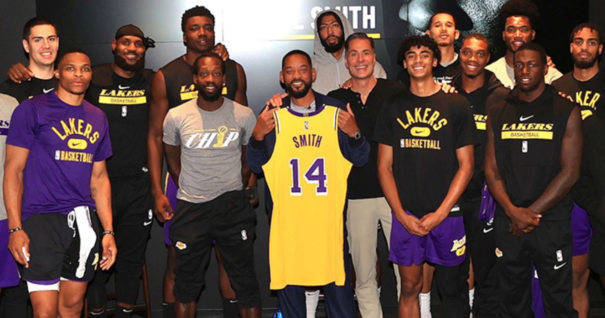 Actor Will Smith, center, poses with the Los Angeles Lakers at the team's facility.