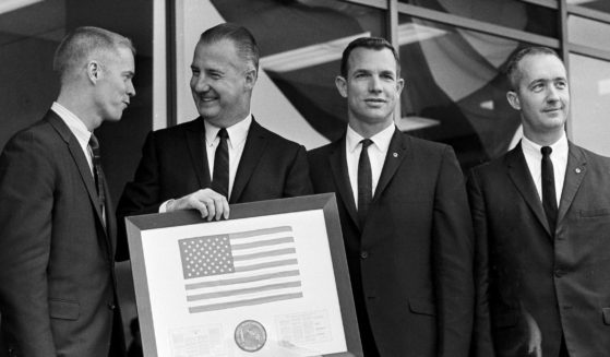 Vice President Spiro Agnew holds a framed American flag presented to him by the crew of Apollo 9, as he poses with the astronauts on March 29, 1969, in Washington. James McDivitt is on the right.