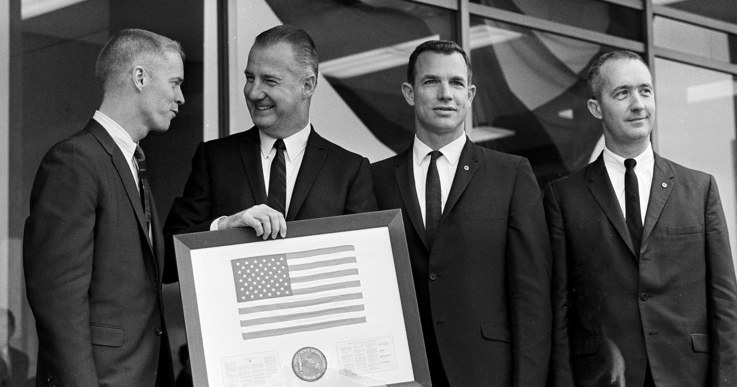Vice President Spiro Agnew holds a framed American flag presented to him by the crew of Apollo 9, as he poses with the astronauts on March 29, 1969, in Washington. James McDivitt is on the right.