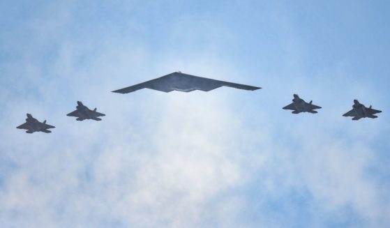 F-22 Raptors and a B-2 Stealth Bomber (C) fly over the Hudson River during the "Salute to America" military flyover on July 4, 2020 in New York City.