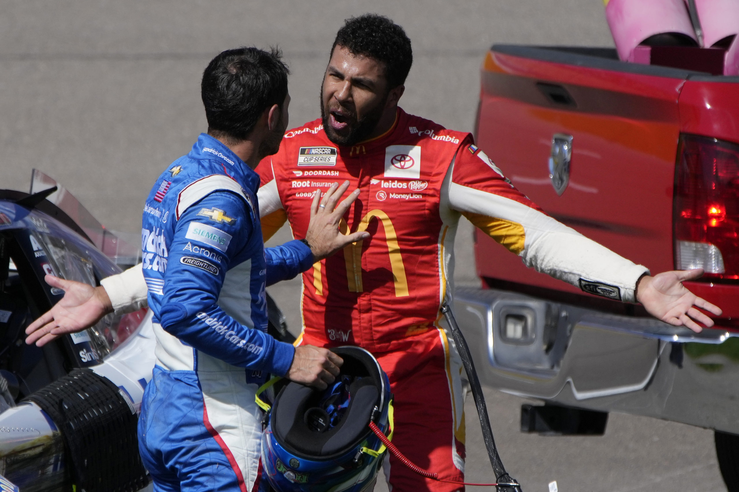 Bubba Wallace, right, argues with Kyle Larson after the two crashed during a NASCAR Cup Series auto race Oct. 16 in Las Vegas.