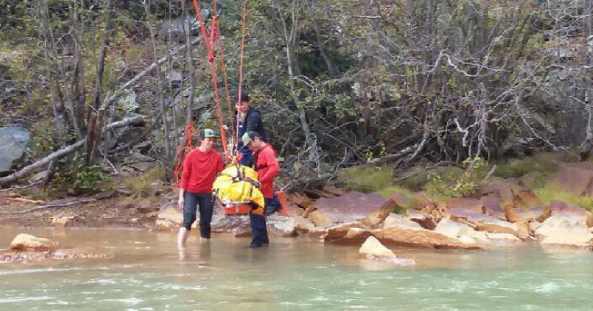 Rescuers use a backboard to bring an injured New Mexico woman out of the wilderness in southwestern Colorado.