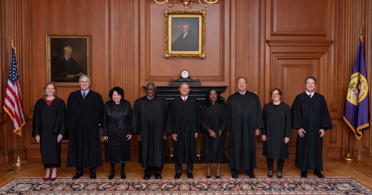 In this image provided by the Supreme Court, members of the Supreme Court pose for a photo during Associate Justice Ketanji Brown Jackson's formal investiture ceremony at the Supreme Court in Washington Sept. 30.