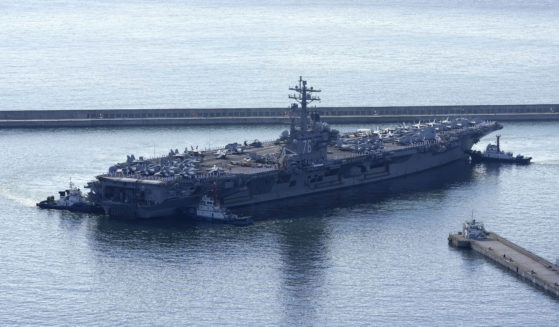 The U.S. carrier USS Ronald Reagan is escorted as it arrives in Busan, South Korea on Sept. 23.