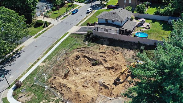 In an aerial view, a residential home is ripped down on September 24, 2022 in Old Bethpage, New York. Photo by Bruce Bennett/Getty Images)
