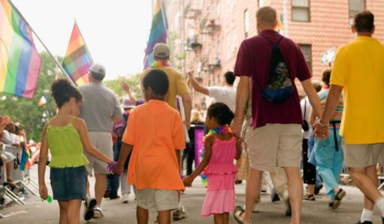 a group of people walking at a gay parade