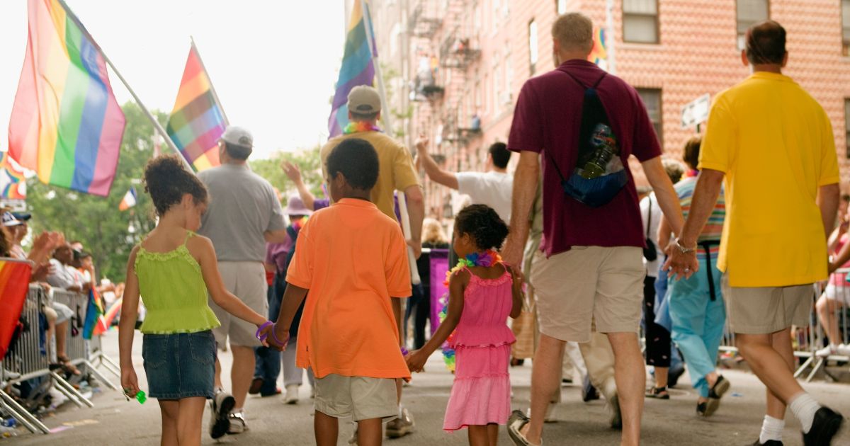 a group of people walking at a gay parade