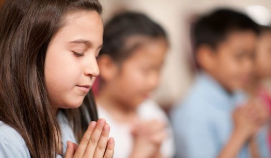 The above stock image is of a girl praying.
