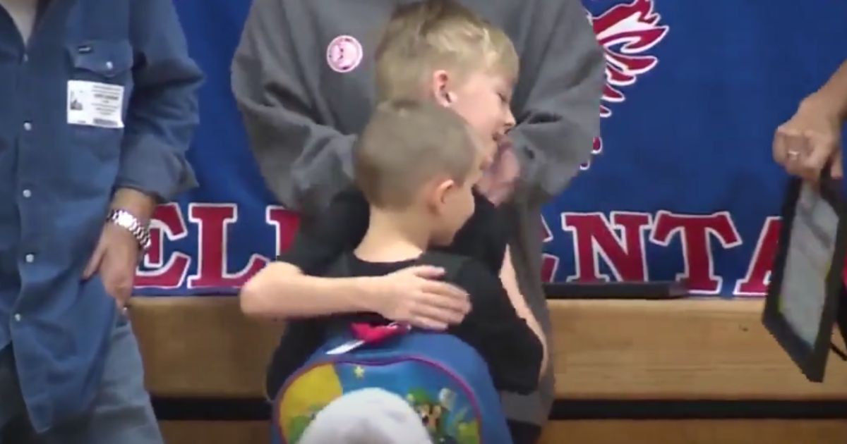 Two boys embrace after one saved the other from choking.