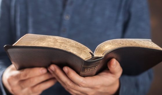 A man reads the Bible in this stock image.