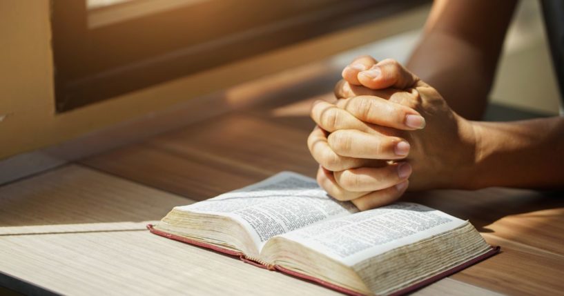 The above stock image is of someone praying.