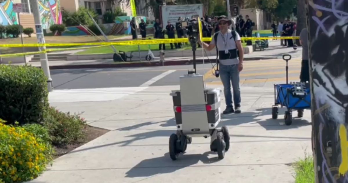 A food delivery robot crosses through police tape in Los Angeles.