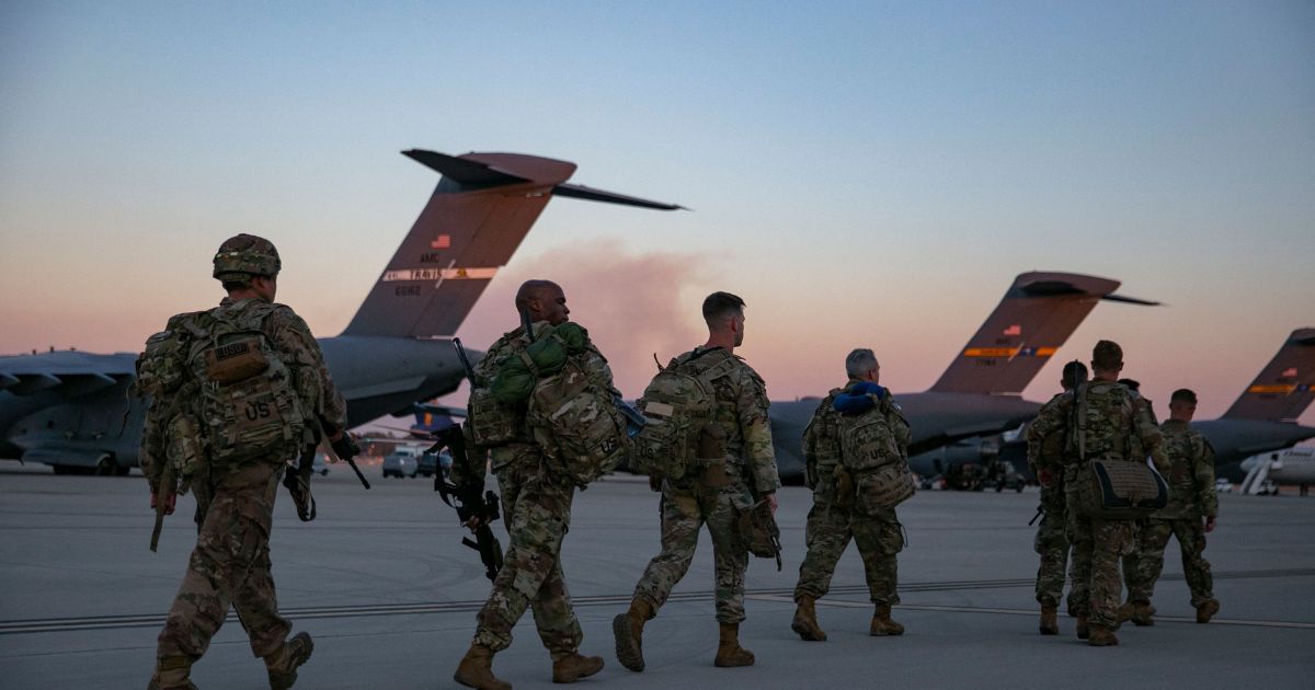 Soldiers of the 82nd Airborne Division walk to board a plane from Pope Army Airfield in Fort Bragg, North Carolina, on Feb. 14, 2021, as they are deployed to Europe.